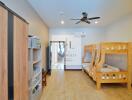 Bedroom with bunk beds, wardrobe, ceiling fan, and wooden floor