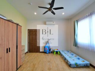 Bedroom with wooden wardrobe, air conditioning, and single bed