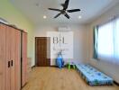 Bedroom with wooden wardrobe, air conditioning, and single bed