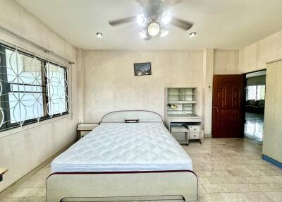 Spacious bedroom with bed and desk