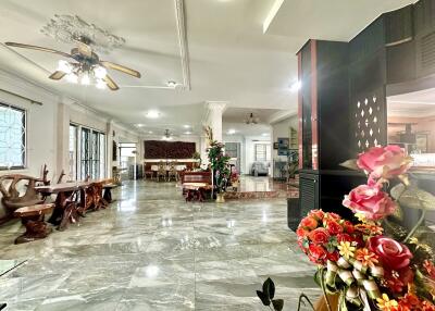 Spacious living room with marble floors and decorative lighting