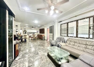 Spacious main living area with marble flooring and large windows