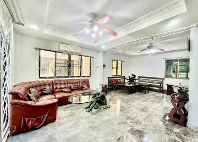 spacious living room with ceiling fans and seating area