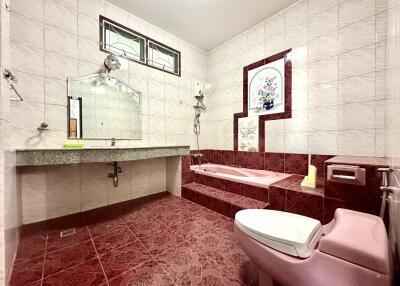 Spacious bathroom with bathtub and modern fixtures