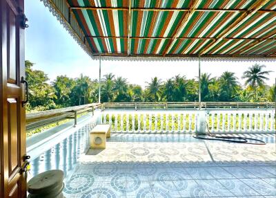 Spacious balcony with tiled flooring and a scenic view of nature.