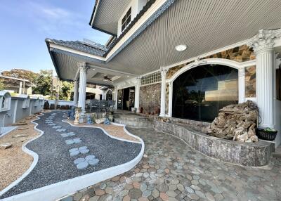 Exterior view of a two-story home with a spacious patio and landscaped walkway