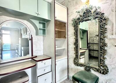 Bedroom with vanity mirror and seating area