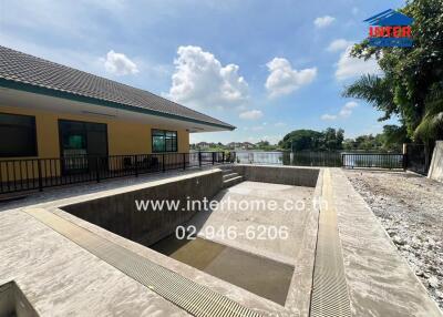 Outdoor area with empty pool and view of a lake