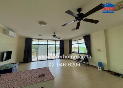 Spacious living room with ceiling fans and large windows