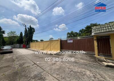 Exterior view of property with gate and driveway