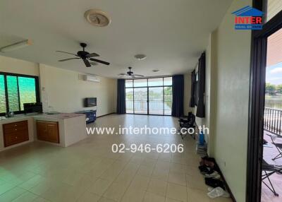 Spacious living room with large window and view of water outside