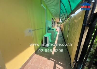 Exterior walkway with green awning