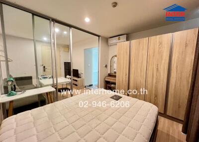 Spacious bedroom with glass sliding doors, a large wardrobe, air conditioning, and a mirror