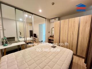 Spacious bedroom with glass sliding doors, a large wardrobe, air conditioning, and a mirror