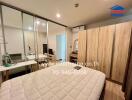 Spacious bedroom with glass sliding doors, a large wardrobe, air conditioning, and a mirror