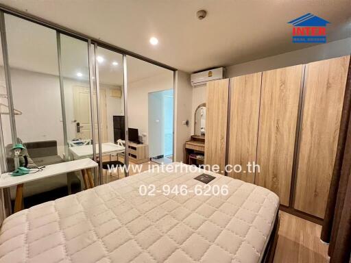 Spacious bedroom with glass sliding doors, a large wardrobe, air conditioning, and a mirror