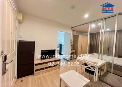 Modern living room with furniture and a view into the bedroom