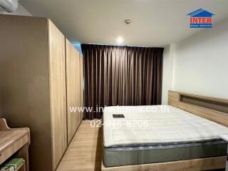 Bedroom with bed, wooden furniture, and ceiling-to-floor curtains.