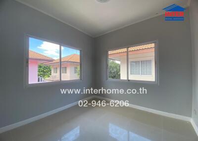 Spacious empty bedroom with large windows and tiled floor