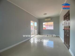 Bright living room with large windows and balcony access