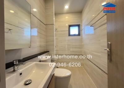 Modern bathroom with sink, toilet, and shower