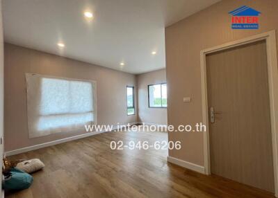 Spacious living area with wooden flooring and ample natural lighting