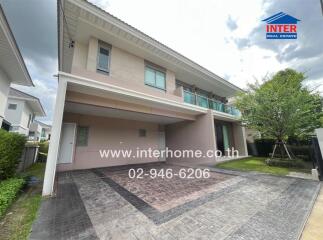 Two-story house with a driveway and a garden