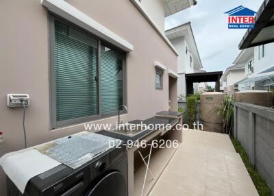 Outdoor laundry and utility area with sink and counter space