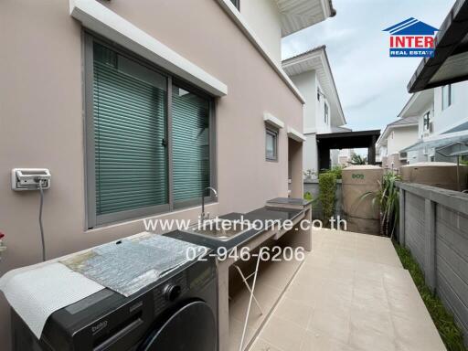 Outdoor laundry and utility area with sink and counter space