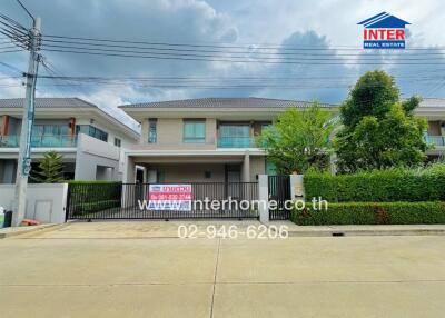 Front view of a modern house with a gated entrance