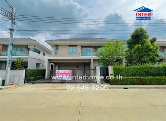 Front view of a modern house with a gated entrance