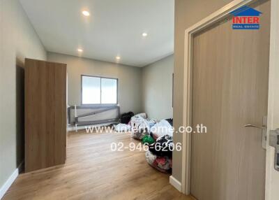 Bedroom with wooden flooring and natural light