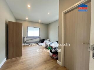 Bedroom with wooden flooring and natural light