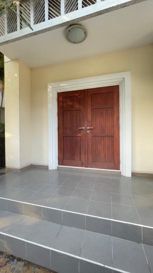 front entrance with wooden double doors