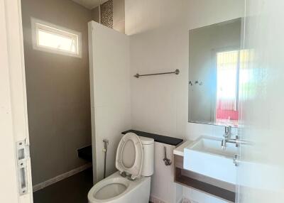 Bathroom with toilet, sink, and tile flooring