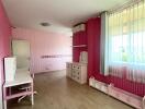 Children's bedroom with pink walls and white furniture