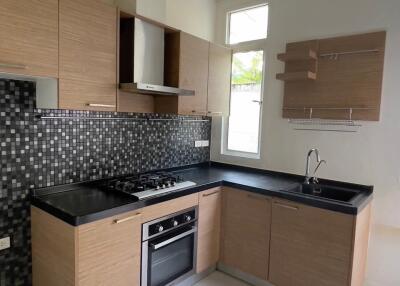 Modern kitchen with wooden cabinets and a minimalist design