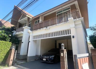 Front view of the house with a car parked in the garage