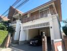 Front view of the house with a car parked in the garage