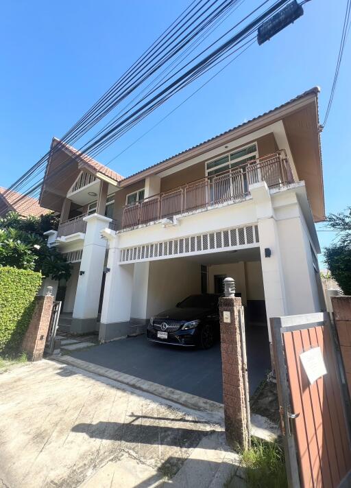 Front view of the house with a car parked in the garage