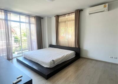 Modern bedroom with large windows and natural light