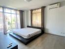 Modern bedroom with large windows and natural light