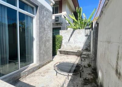 Outdoor area with a trampoline and adjacent building