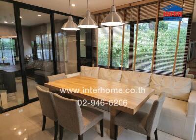 Modern dining area with glass doors and large windows