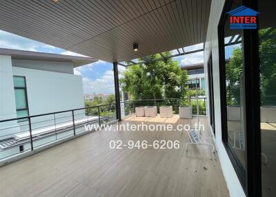 Spacious balcony with seating area and city views