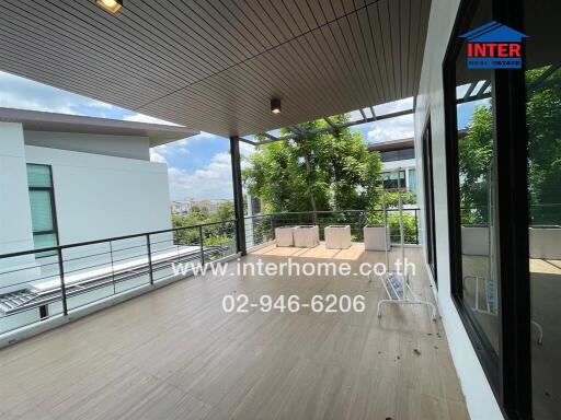 Spacious balcony with seating area and city views