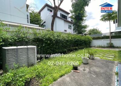 Outdoor garden area with pathway and greenery