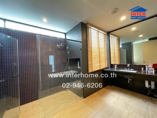 Modern bathroom with mosaic tile shower and large vanity