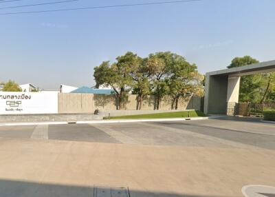 Gated residential entrance with greenery