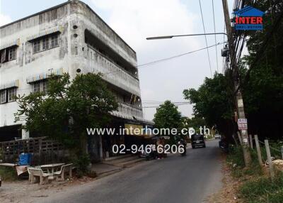 Exterior view of a building on a street with few vehicles